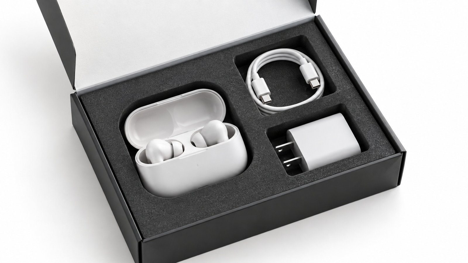 Open retail box with die-cut foam tray holding earbuds, a charging cable, and a charger